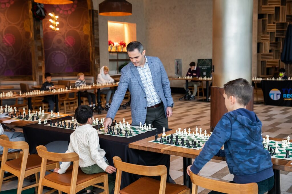 Grandmaster Rashad Babaev teaching chess to kids during a group coaching session at GMChessPrep