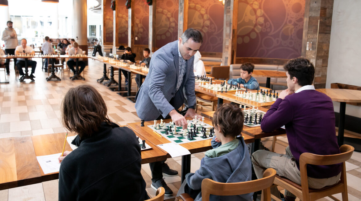 Grandmaster Rashad Babaev Coaching Young Players During a Chess Tournament