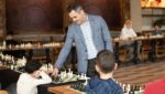 Grandmaster chess coach guiding young students during a chess lesson at GMChessPrep Academy